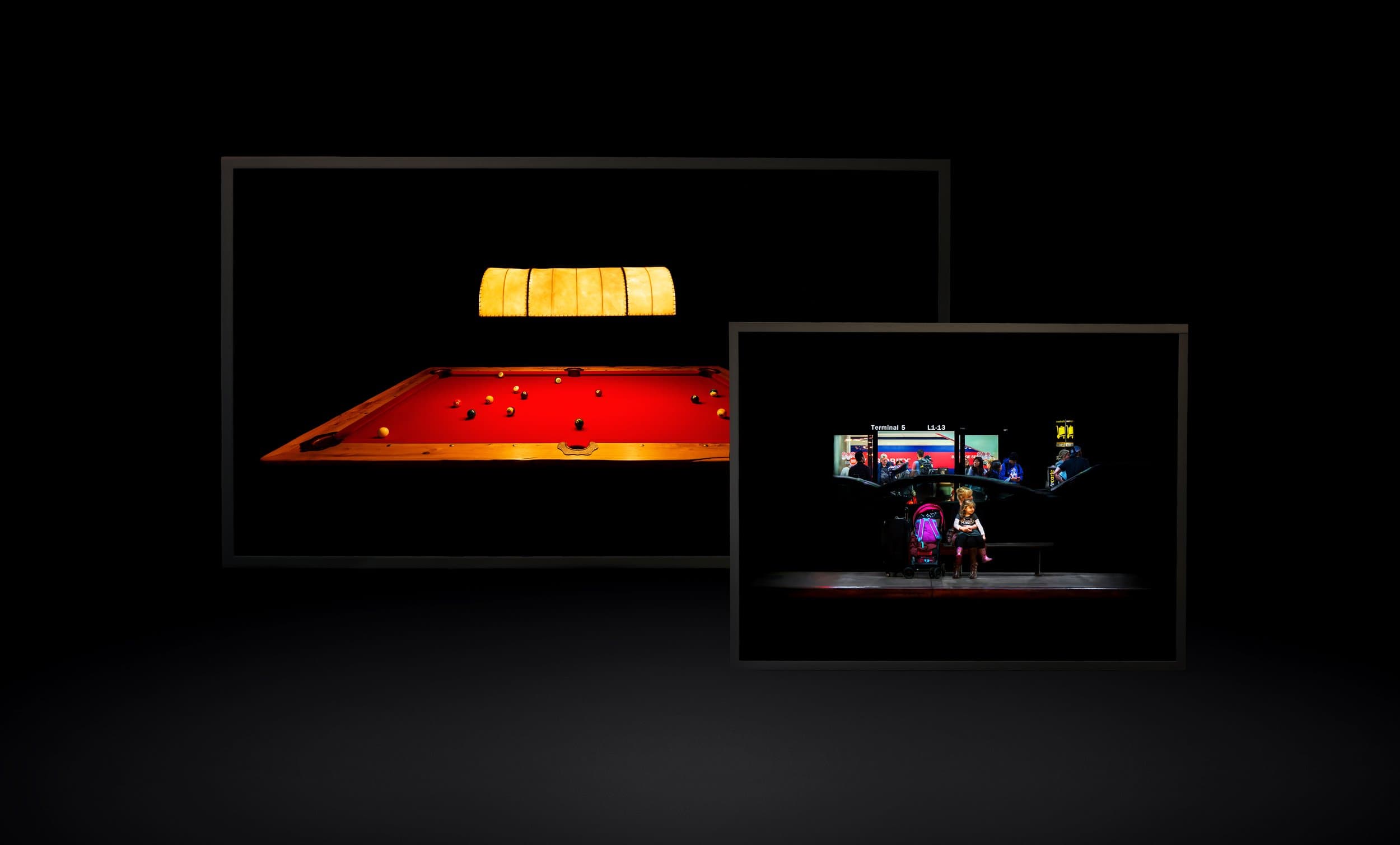 Lightbox installations of photographs in a dark room